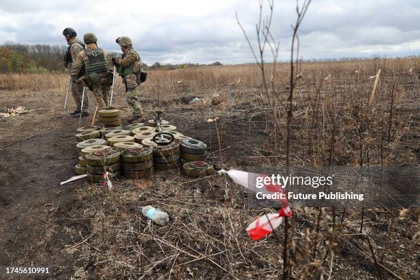 Experts of a consolidated squad of the Explosives Service of Ukraine carry out demining works in Kharkiv Region, northeastern Ukraine.