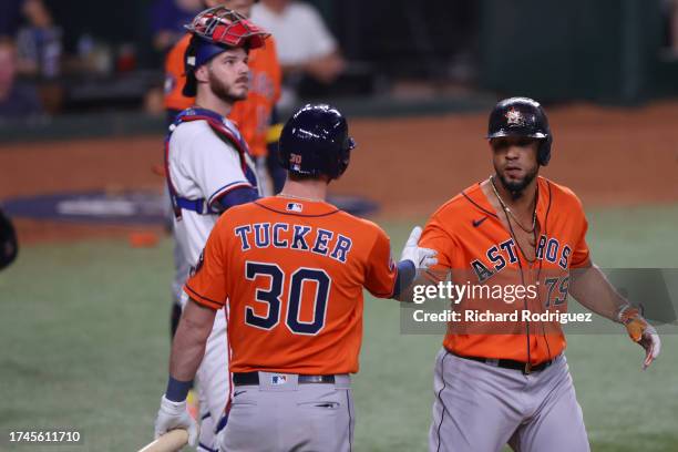 Kyle Tucker and José Abreu of the Houston Astros celebrate after Abreu hit a home run in the fourth inning against the Texas Rangers during Game Four...