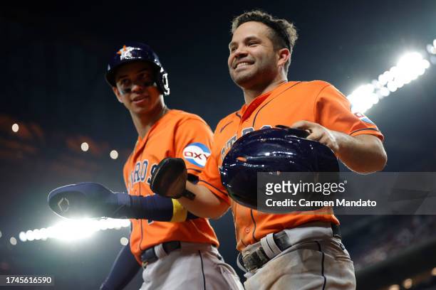 Mauricio Dubón and Jose Altuve of the Houston Astros celebrate after scoring runs in the fourth inning against the Texas Rangers during Game Four of...