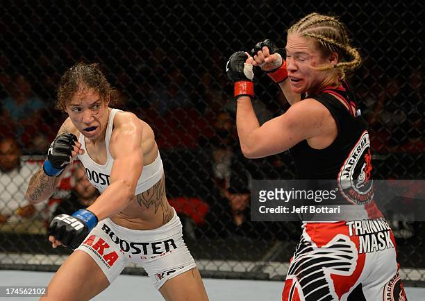 Germaine de Randamie punches Julie Kedzie in their bantamweight bout during the UFC on FOX event at Key Arena on July 27, 2013 in Seattle, Washington.