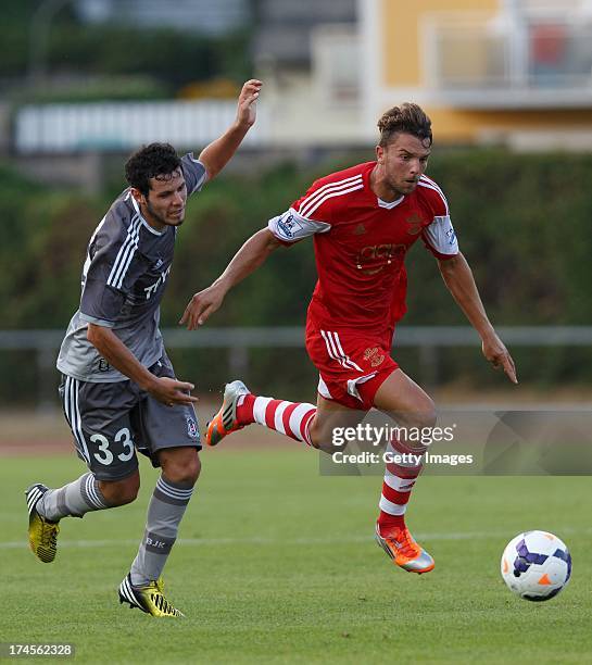 Pedro Franco of Besiktas and Jay Rodriguez of Southampton compete for the ball during the preseason friendly match between Southampton FC and...