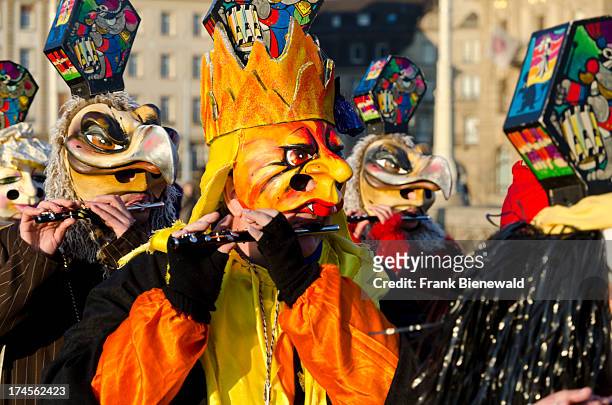 Hundred different groups of masked people walk through the streets of Basel for 3 days and nights at "Basler Fasnet", playing music all the time..