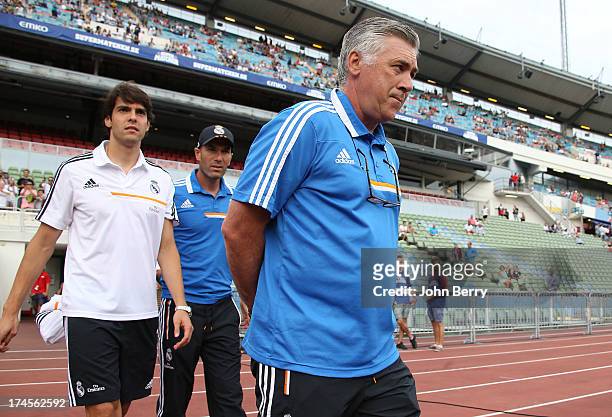 Kaka of Real Madrid, assistant-coach Zinedine Zidane, Carlo Ancelotti, coach of Real Madrid enter the field prior to the friendly match between Real...