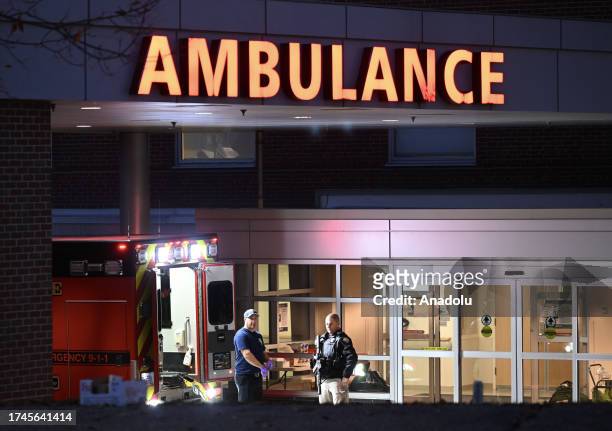 Police officers close the road as they patrol around the hospital during inspection after a gunman's multiple shootings in Maine, United States on...