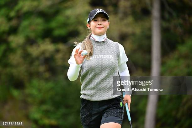 Yuri Yoshida of Japan acknowledges the gallery on the 1st green during the second round of NOBUTA Group Masters GC Ladies at Masters Golf Club on...