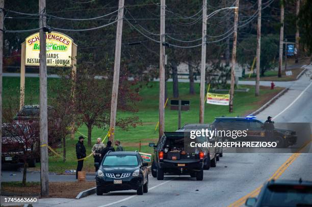 Police presence at Schemengees Bar where a mass shooting occurred yesterday in Lewiston, Maine on October 26, 2023. A massive manhunt was under way...