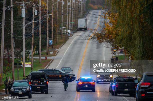 Police presence at Schemengees Bar where a mass shooting occurred yesterday in Lewiston, Maine on October 26, 2023. A massive manhunt was under way...