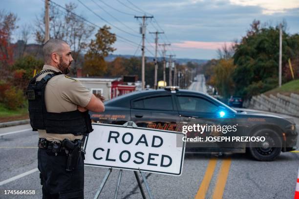 Police presence at Schemengees Bar where a mass shooting occurred yesterday in Lewiston, Maine on October 26, 2023. A massive manhunt was under way...