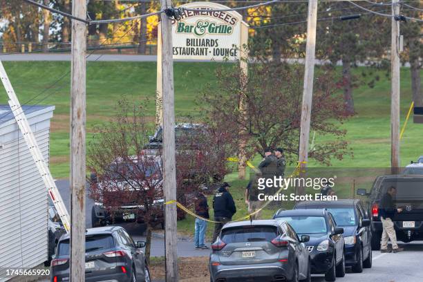 Law enforcement officials investigate outside the Schemengees Bar and Grille on October 26, 2023 in Lewiston, Maine. Police are still searching for...