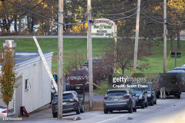 Law enforcement officials investigate outside the Schemengees Bar and Grille on October 26, 2023 in Lewiston, Maine. Police are still searching for...