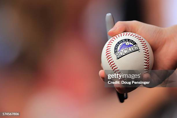 Young fan holds a baseball hoping to get an autograph as the Milwaukee Brewers face the Colorado Rockies at Coors Field on July 27, 2013 in Denver,...