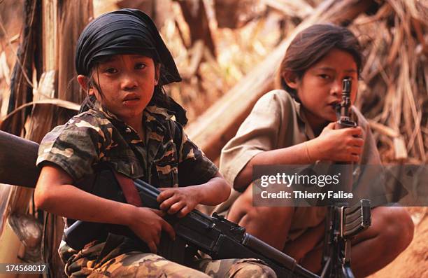 Kamerplaw, southern Burma - headquarters of God's Army. Luther Htoo with another child-soldier. Luther and his twin brother were messianic...