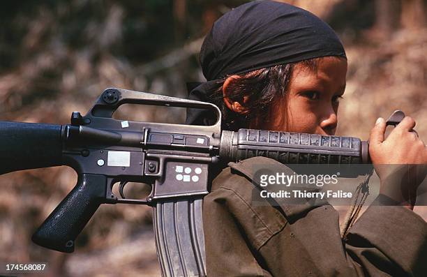 Per Ler, a 12 year-old soldier in Kamerplaw, southern Burma, headquarters of God's Army, a ragtag breakaway guerrilla faction of the Christian Karen...