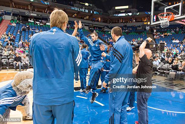 Kevin Love of the Minnesota Timberwolves is greeted by teammates during the preseason game between the of the Minnesota Timberwolves and the Maccabi...