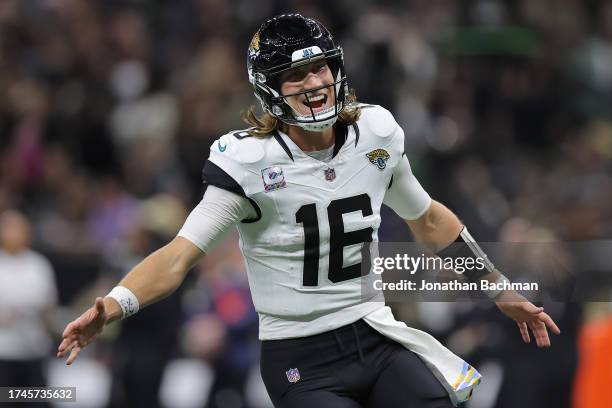 Trevor Lawrence of the Jacksonville Jaguars celebrates after throwing a 44-yard touchdown pass to Christian Kirk during the fourth quarter against...