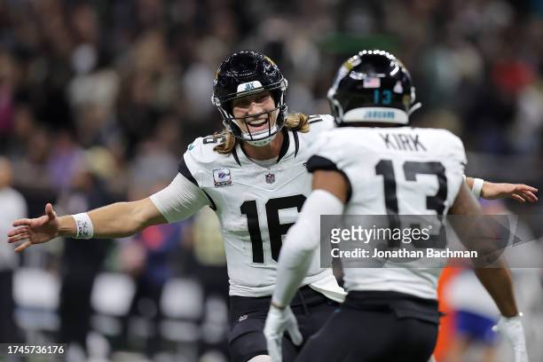 Trevor Lawrence of the Jacksonville Jaguars celebrates after throwing a 44-yard touchdown pass to Christian Kirk during the fourth quarter against...