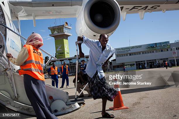 Ahmed Katib Omar, who lost his leg to a bullet in Mogadishu, returns to his native Zanzibar after more than ten years as a refugee in Somalia, July...