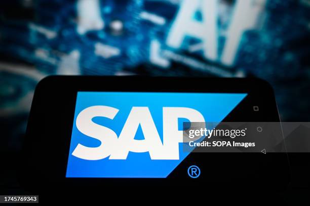 In this photo illustration, the SAP logo is displayed on a smartphone with Artificial Intelligence graphics in the background.