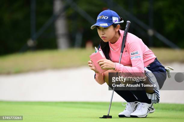 Nana Suganuma of Japan lines up a putt on the 1st green during the second round of NOBUTA Group Masters GC Ladies at Masters Golf Club on October 20,...