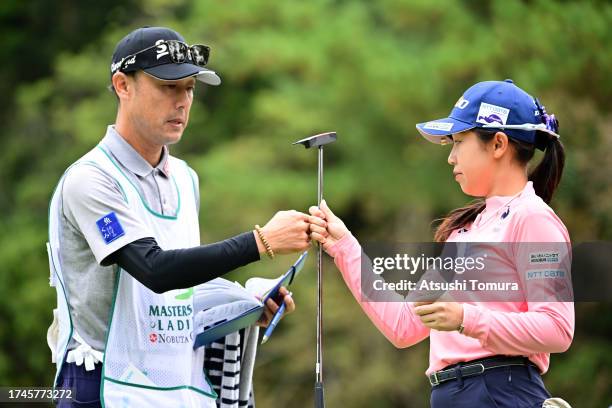 Nana Suganuma of Japan fist bumps with her caddie after the birdie on the 1st green during the second round of NOBUTA Group Masters GC Ladies at...