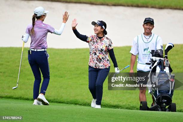 Serena Aoki of Japan high fives with Yuka Yasuda of Japan after making a chip-in-eagle on the 1st hole during the second round of NOBUTA Group...