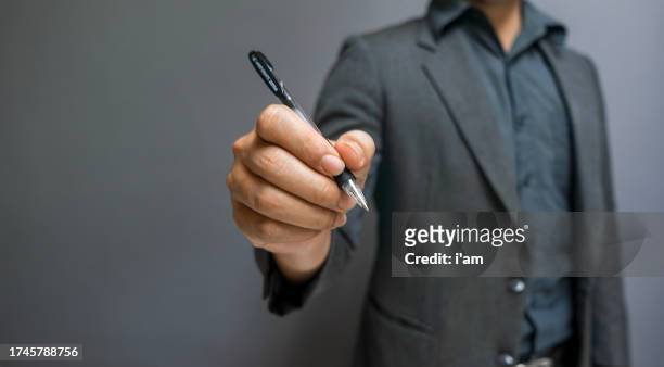 businessman writing, drawing on the screen - holding pen in hand stock pictures, royalty-free photos & images