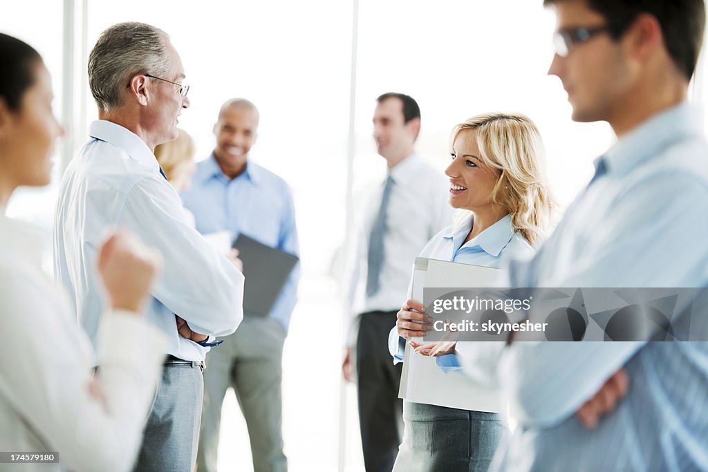 Group of professional businessmen and women talk