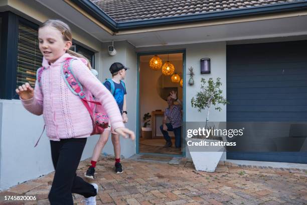 children leave the house to go to school - child waving stock pictures, royalty-free photos & images