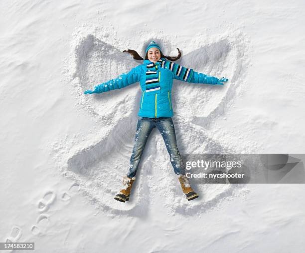 snow angel fun - snow fun stock pictures, royalty-free photos & images