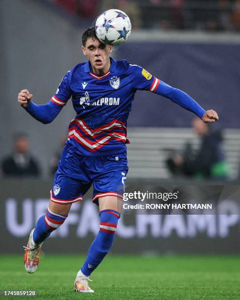 Red Star's Serbian defender Kosta Nedeljkovic heads the ball during the UEFA Champions League football match between RB Leipzig and FK Crvena Zvezda...