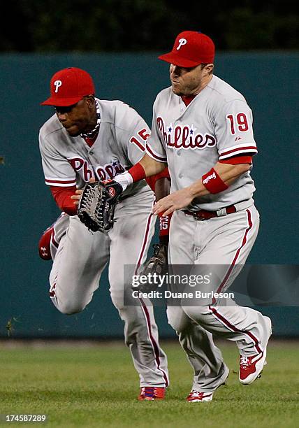 Center fielder John Mayberry of the Philadelphia Phillies tries to avoid colliding with right fielder Laynce Nix after catching a fly ball hit by...