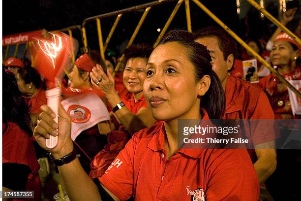 Demonstrator waves a foot clapper, which has become the pro-government movement's symbol in response to the hand clappers used by their...