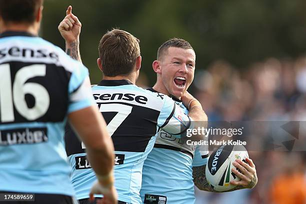 Todd Carney of the Sharks celebrates scoring a try during the round 20 NRL match between the Cronulla Sharks and the Penrith Panthers at Remondis...