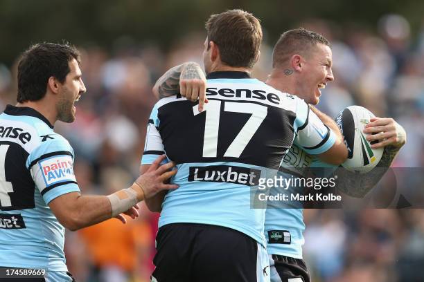 Todd Carney of the Sharks celebrates with his team mates after scoring a try during the round 20 NRL match between the Cronulla Sharks and the...