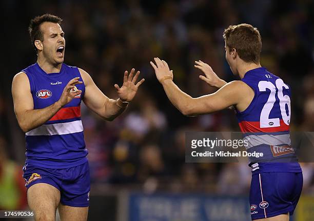 Tory Dickson and Lachie Hunter of the Bulldogs celebrate a goal during the round 18 AFL match between the Western Bulldogs and the West Coast Eagles...