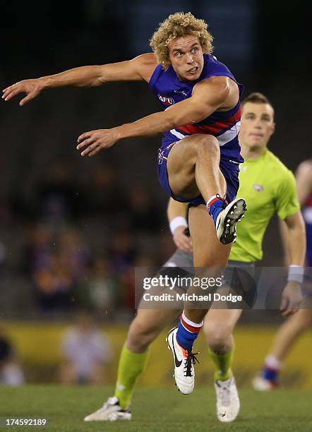 Mitch Wallis of the Bulldogs kicks the ball during the round 18 AFL match between the Western Bulldogs and the West Coast Eagles at Etihad Stadium on...