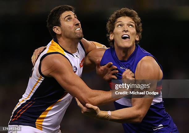 Will Minson of the Bulldogs and Dean Cox of the Eagles contest for the ball during the round 18 AFL match between the Western Bulldogs and the West...