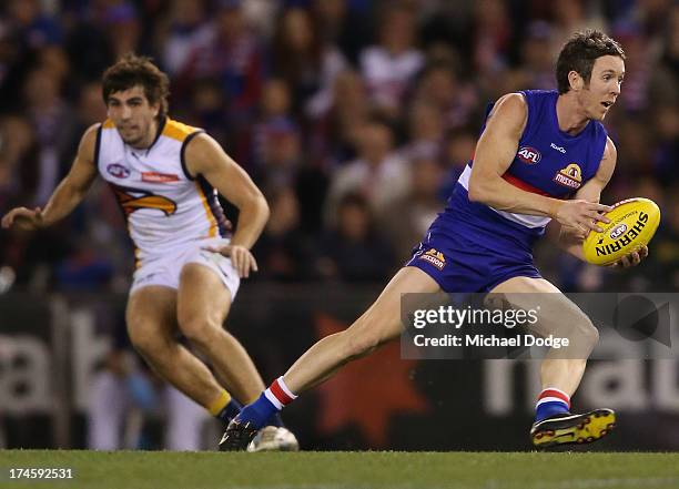 Robert Murphy of the Bulldogs runs with the ball during the round 18 AFL match between the Western Bulldogs and the West Coast Eagles at Etihad...