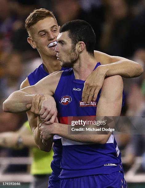 Liam Jones and Jarrad Grant of the Bulldogs celebrate a goal during the round 18 AFL match between the Western Bulldogs and the West Coast Eagles at...