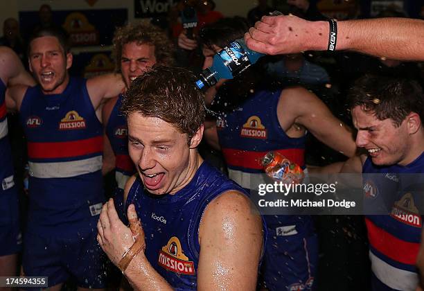 Lachie Hunter of the Bulldogs celebrates his first win with the club during the round 18 AFL match between the Western Bulldogs and the West Coast...