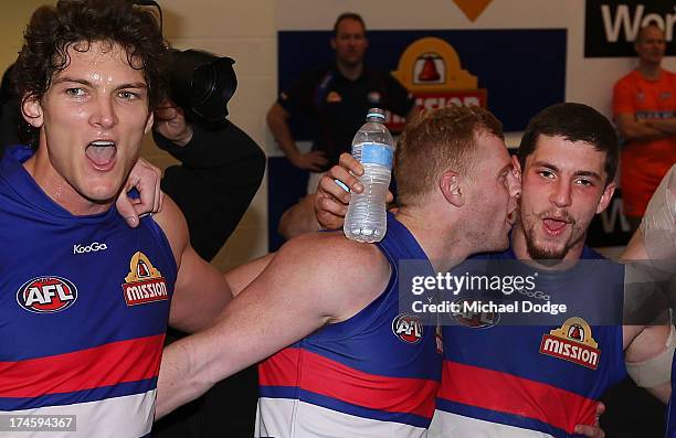 Will Minson Adam Cooney and Tom Liberatore and Luke Dahlhaus of the Bulldogs celebrate their win during the round 18 AFL match between the Western...