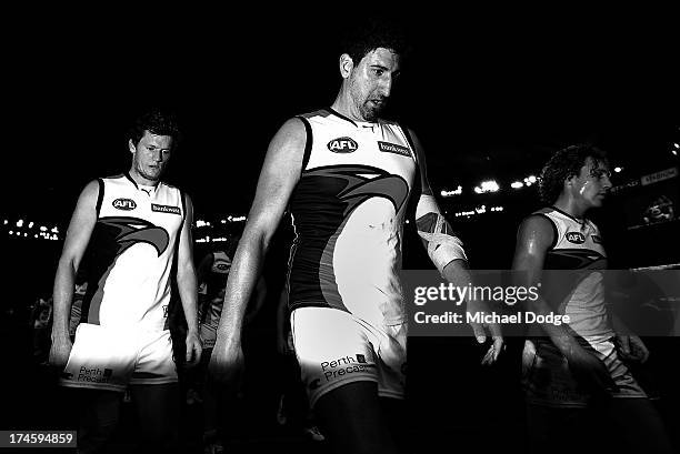 Cale Morton Dean Cox and Matt Priddis of the Eagles walks off after their defeat during the round 18 AFL match between the Western Bulldogs and the...