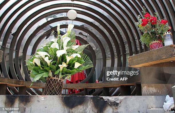 Flowers are left on a bench for victims two days after a bomb attack at a popular restaurant in Cagaya de Oro on the southern Philippine island of...