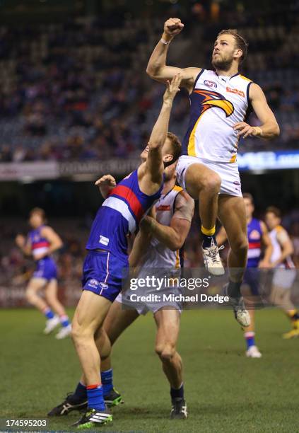 Liam Jones of the Bulldogs and Will Scholfield of the Eagles contest for the ball during the round 18 AFL match between the Western Bulldogs and the...