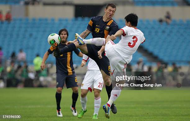 Mitchell Duke of Australia clashes with Sun Xiang of China during the EAFF East Asian Cup match between Australia and China at Jamsil Stadium on July...