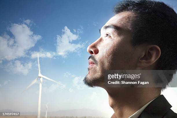 man's profile in front of windmills - chinese man looking up bildbanksfoton och bilder