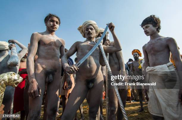 Naked Naga sadhus, holy men, posing after Shahi Snan, the main bath at the Sangam, the confluence of the rivers Ganges, Yamuna and Saraswati, at...