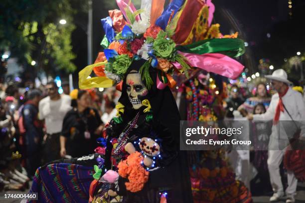 October 22 Mexico City, Mexico: A person dressed as a 'Catrina' takes part in the Annual Mega Parade of Catrinas 2023 during Day of the Dead...