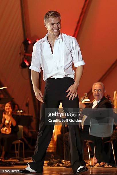 Derek Hough smiles as he looks at partner Emma Slater after they danced to Glenn Miller's "In The Mood" during the California Philharmonic Festival...
