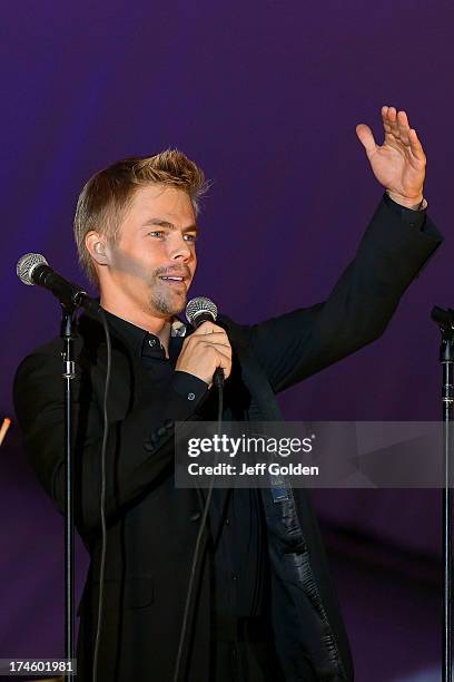 Derek Hough waves good night to the audience after singing "Feeling Good" during the California Philharmonic Festival on the Green at Santa Anita...